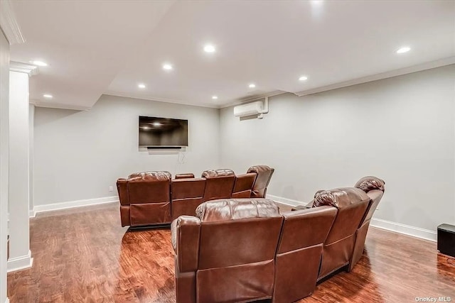 cinema room featuring recessed lighting, baseboards, wood finished floors, and a wall mounted AC