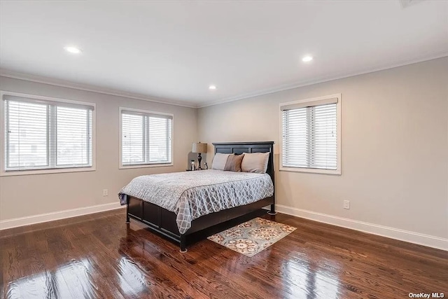 bedroom featuring dark wood-style floors, baseboards, and ornamental molding