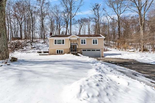 bi-level home featuring a garage and a chimney