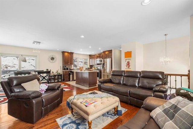 living room featuring an inviting chandelier, visible vents, dark wood-style floors, and recessed lighting