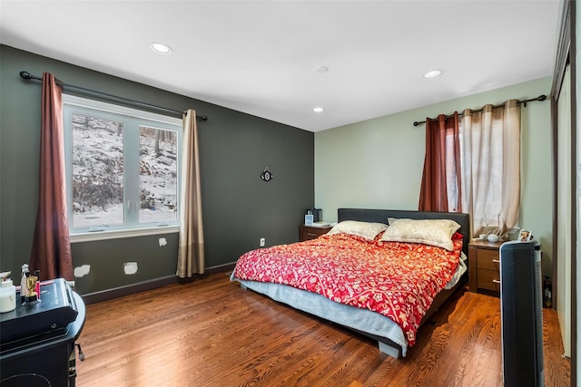 bedroom with recessed lighting, wood finished floors, and baseboards