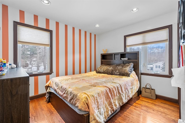 bedroom with baseboards, multiple windows, light wood-style flooring, and recessed lighting