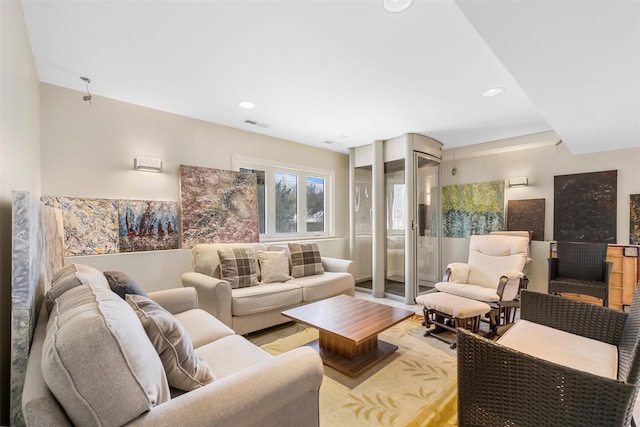 living area with light wood-style floors, recessed lighting, and visible vents