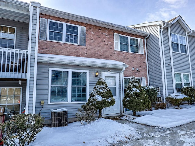 multi unit property featuring brick siding and cooling unit