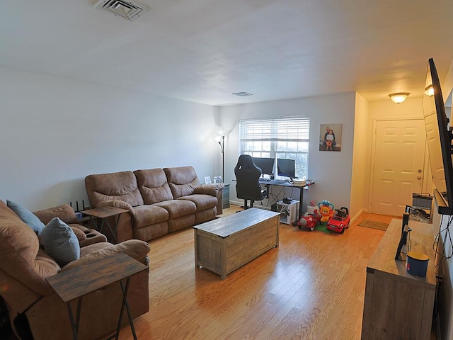 living area with light wood finished floors and visible vents