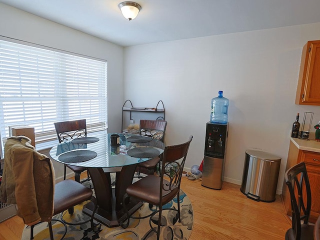 dining room with light wood-type flooring and baseboards