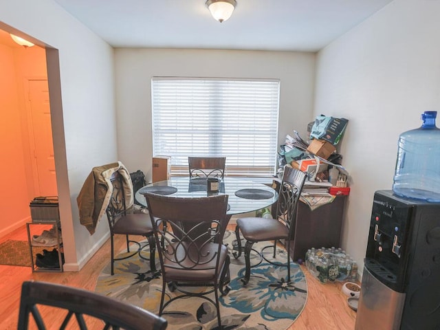 dining area featuring wood finished floors and baseboards