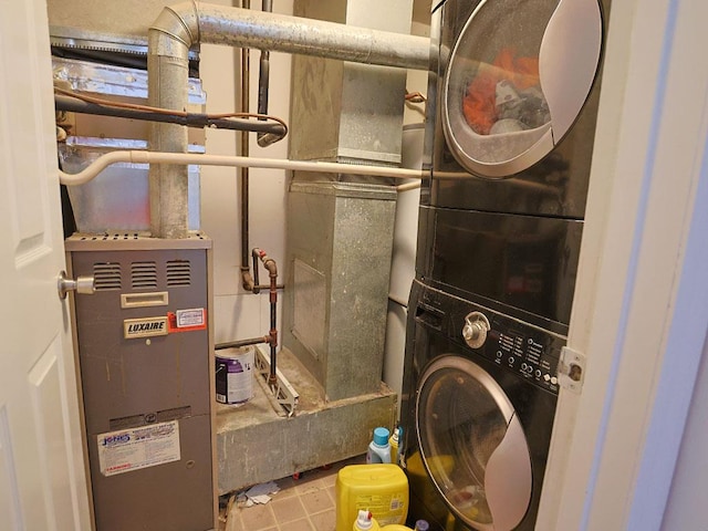 utility room with stacked washer and dryer