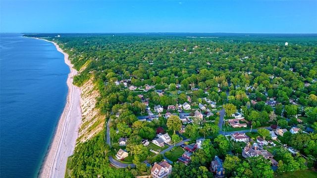 aerial view with a residential view, a water view, a beach view, and a forest view