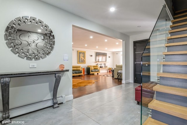 interior space with recessed lighting, concrete floors, baseboard heating, and stairs