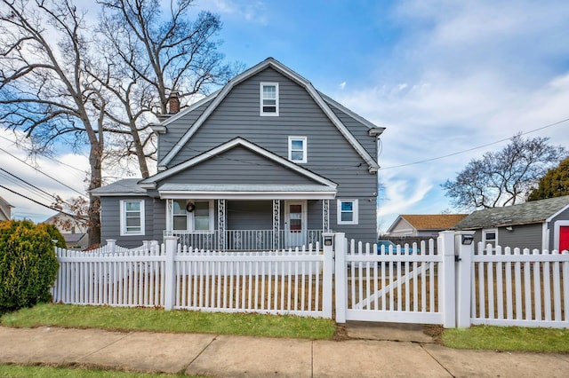 dutch colonial featuring a fenced front yard, a gate, a porch, and a gambrel roof