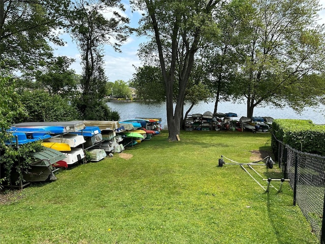 view of yard featuring a water view and fence