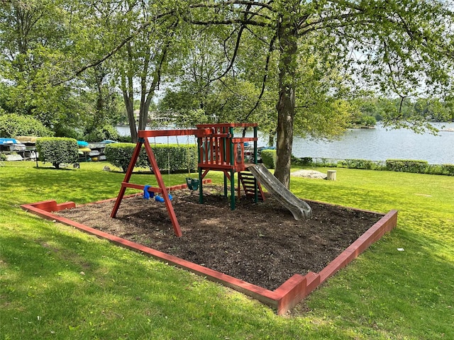 view of play area featuring a water view and a lawn