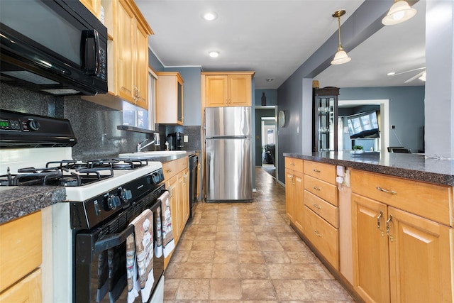 kitchen with a sink, black appliances, tasteful backsplash, dark countertops, and pendant lighting