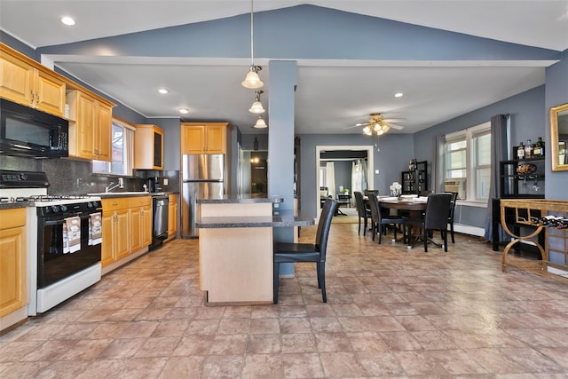 kitchen with a healthy amount of sunlight, black appliances, backsplash, and a center island