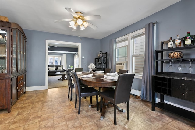 dining room featuring ceiling fan and baseboards