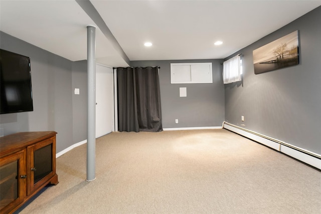 basement with carpet floors, a baseboard radiator, baseboards, and recessed lighting