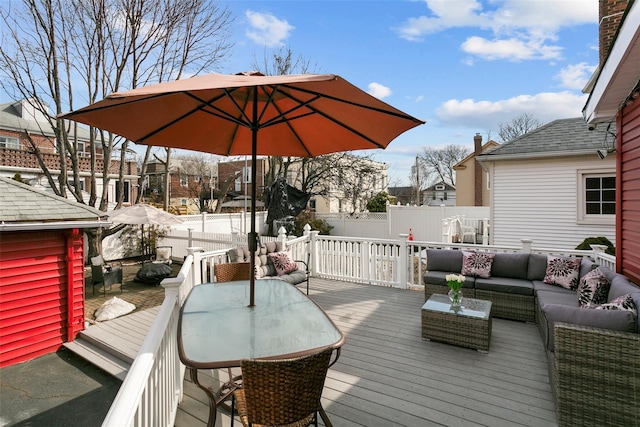 wooden terrace featuring a fenced backyard, an outdoor living space, and outdoor dining space