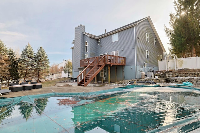 view of swimming pool with fence private yard, outdoor lounge area, a deck, and stairs