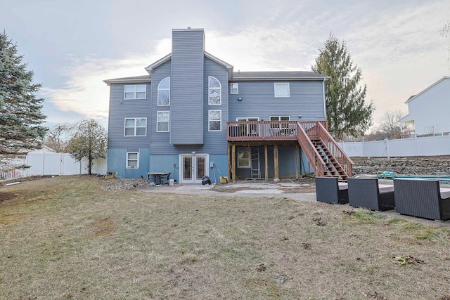 back of house featuring french doors, a lawn, a deck, cooling unit, and stairs