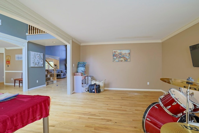 playroom with crown molding, baseboards, and wood finished floors