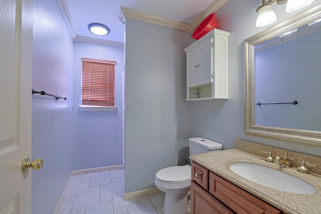 bathroom featuring baseboards, vanity, toilet, and crown molding