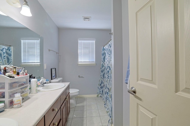 bathroom with double vanity, visible vents, toilet, tile patterned floors, and a sink