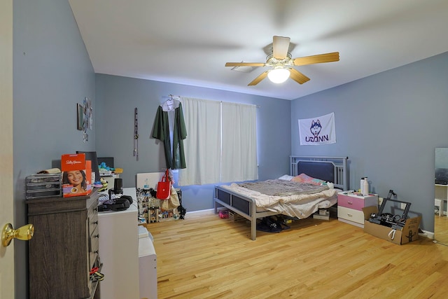 bedroom with ceiling fan and wood finished floors