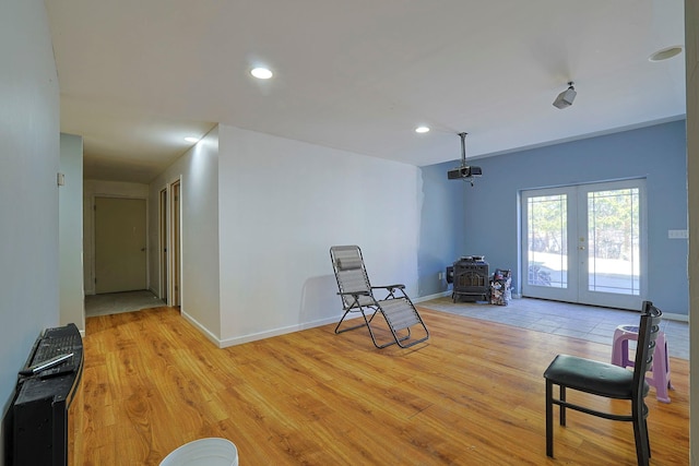 living area with light wood-type flooring, french doors, and recessed lighting