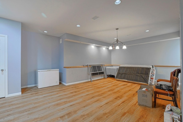 unfurnished room featuring recessed lighting, wood finished floors, and baseboards