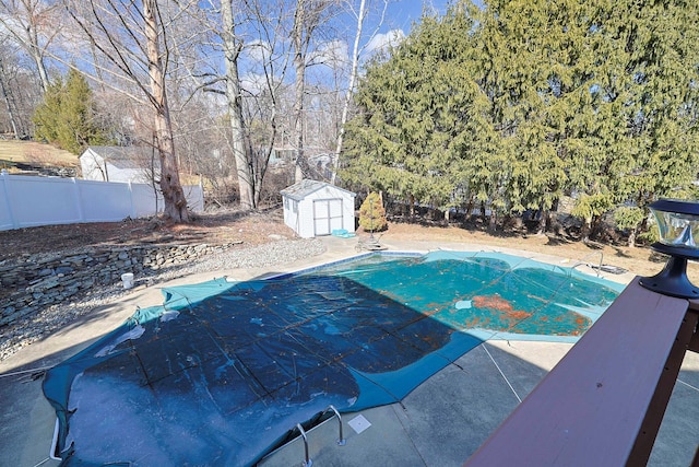 view of swimming pool with a fenced in pool, a patio, a storage shed, fence, and an outdoor structure