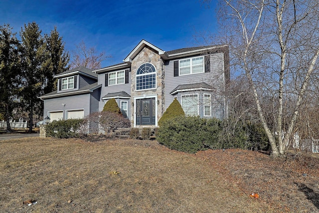 traditional home featuring a garage and stone siding