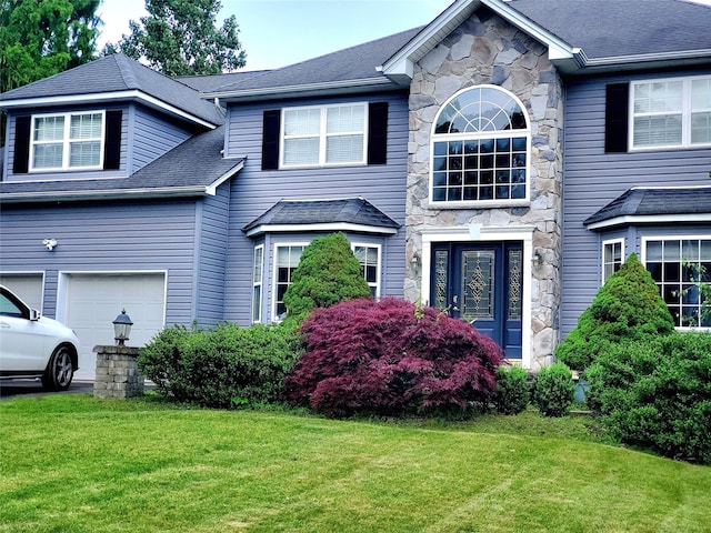 1010 Pine Vw, New Windsor, NY 12553 - traditional-style home featuring stone siding, a front yard, and an attached garage