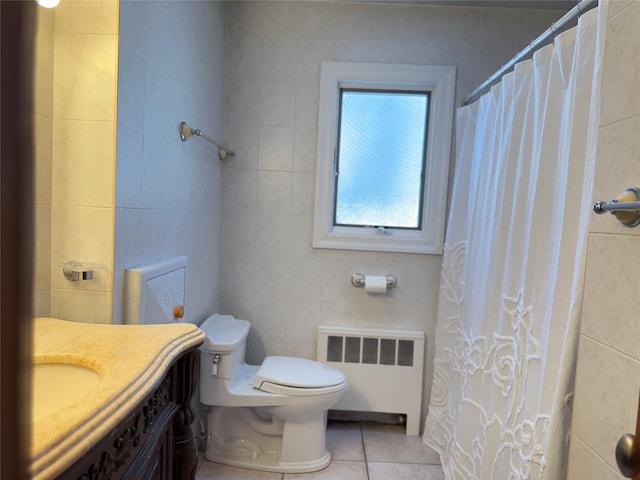 full bathroom featuring radiator, tile walls, toilet, and tile patterned floors