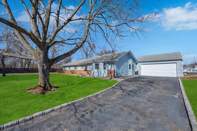 single story home with aphalt driveway, a front yard, and a garage