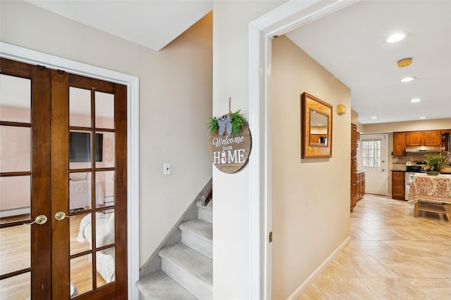 stairs featuring recessed lighting, french doors, baseboards, and tile patterned floors