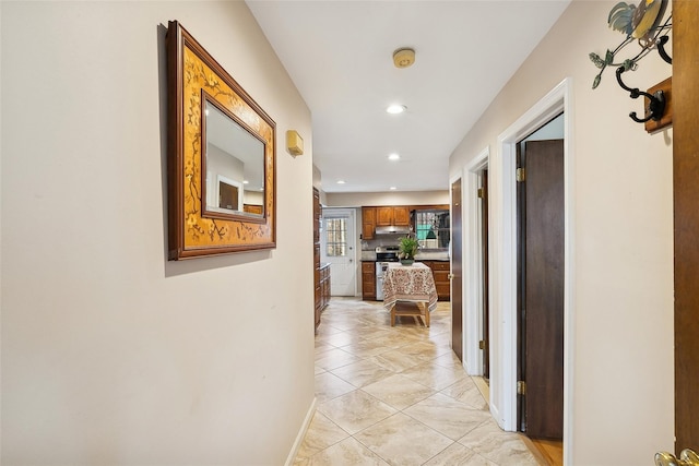 corridor with light tile patterned floors and recessed lighting