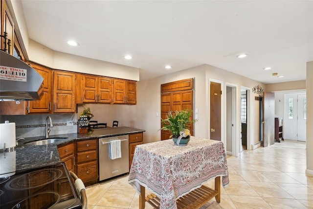 kitchen with brown cabinetry, dishwasher, dark stone countertops, extractor fan, and a sink