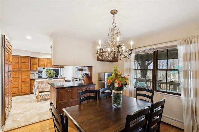 dining area featuring a baseboard radiator and recessed lighting