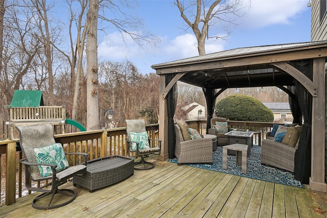 wooden deck featuring outdoor lounge area and a gazebo