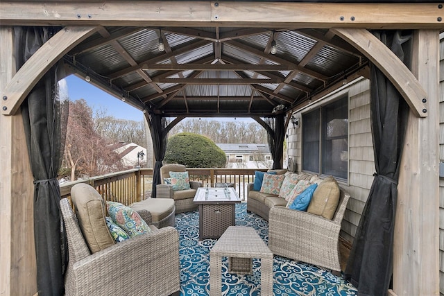 wooden deck with an outdoor living space and a gazebo