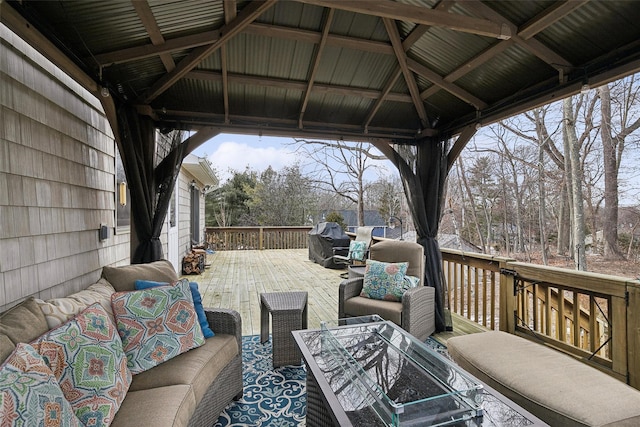 wooden deck featuring a gazebo and an outdoor hangout area