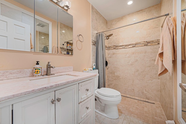 full bathroom with toilet, visible vents, a tile shower, and vanity