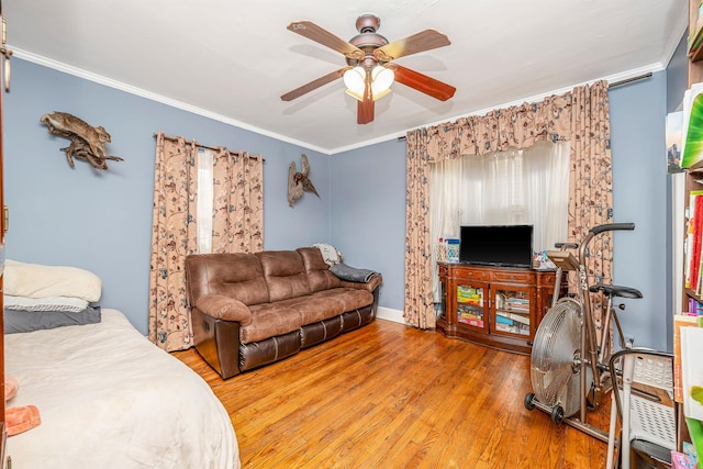 bedroom featuring ornamental molding, ceiling fan, and wood finished floors