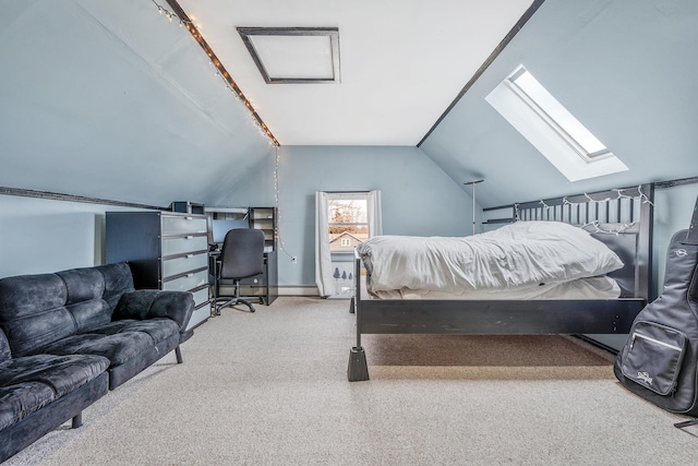 bedroom featuring vaulted ceiling with skylight and carpet flooring