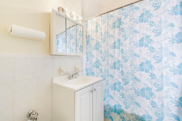 full bathroom with tile walls and vanity