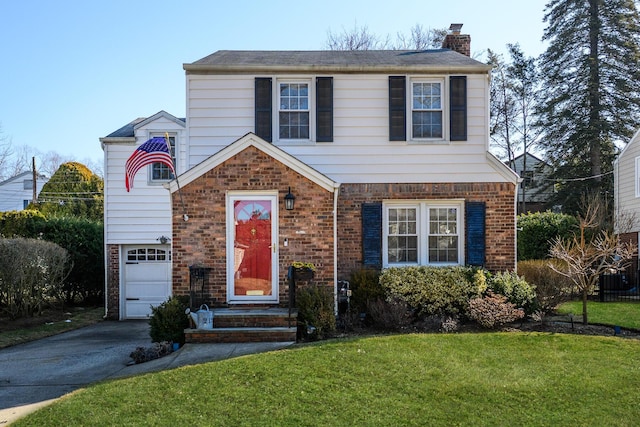 view of front of house with driveway, brick siding, and a front lawn