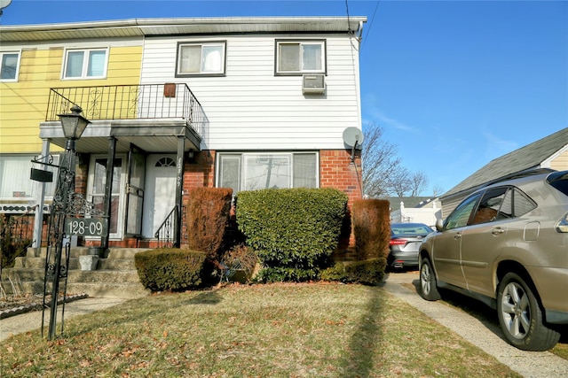 multi unit property with brick siding and a front lawn