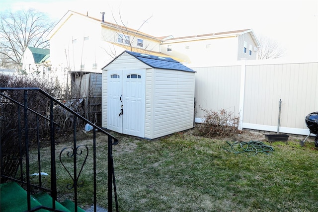 view of shed with fence