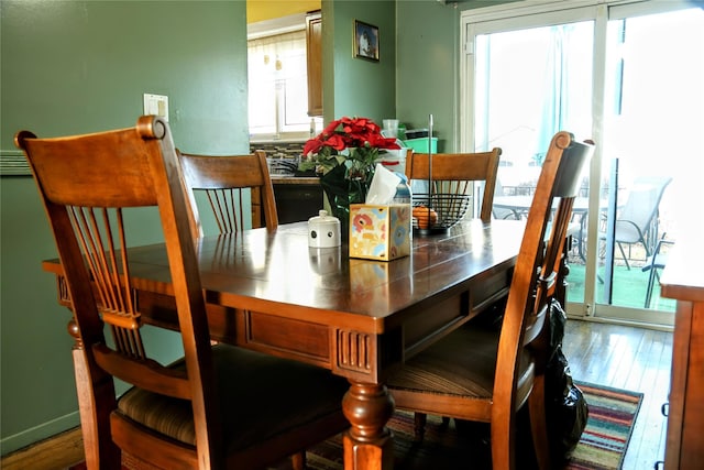 dining space with wood finished floors and a wealth of natural light